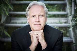 Dirigent Markus Stenz auf seinen Händen unter dem Kinn gelehnt
